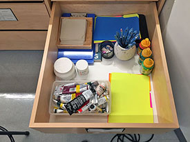 Pastel storage drawer has individual pastel trays for art students to use in class.