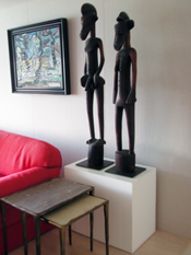 Art Boards Sculpture base holding Senufo Rhythm Pounder male and female figures from Africa.