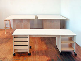 Rolling maple tables are beautiful with doors below for art storage.