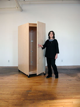 Deep art storage cabinet with locking door for storing fine art safely.