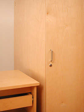 Art Storage desk next to art storage locking cabinet for storing art.