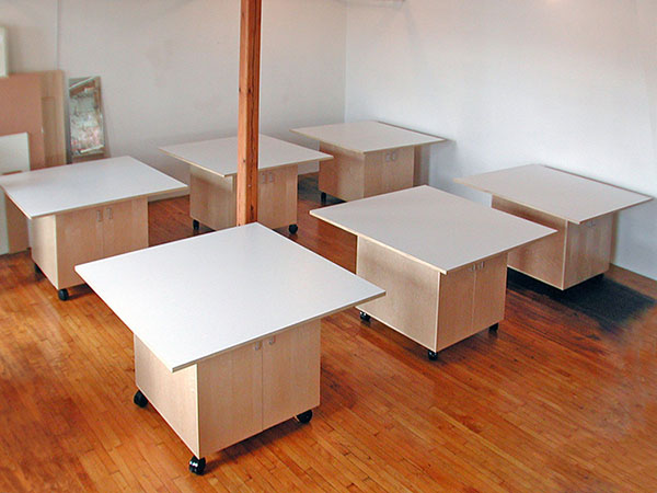 Six rolling art studio tables designed by Art Boards™ for a school library. Students can use these art studio library tables while standing or sitting. 