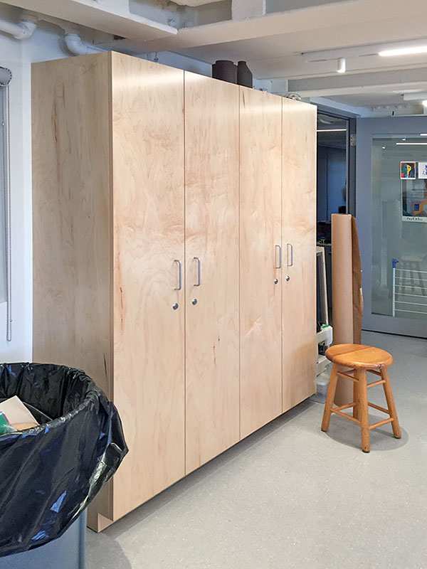 School art room has tall art storage closet doors with that lock with keys for secure storage in the school art studio classroom, made by Art Boards™.