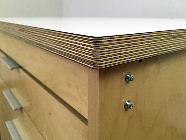 Art Boards™ Mobile Art Studio Worktable for making and storing art is 42 1/2" x 35 1/2" The top counter is 1" thick. The counter is a white high pressure laminate surface. The sides are hand rubbed urethane for a fine finish.