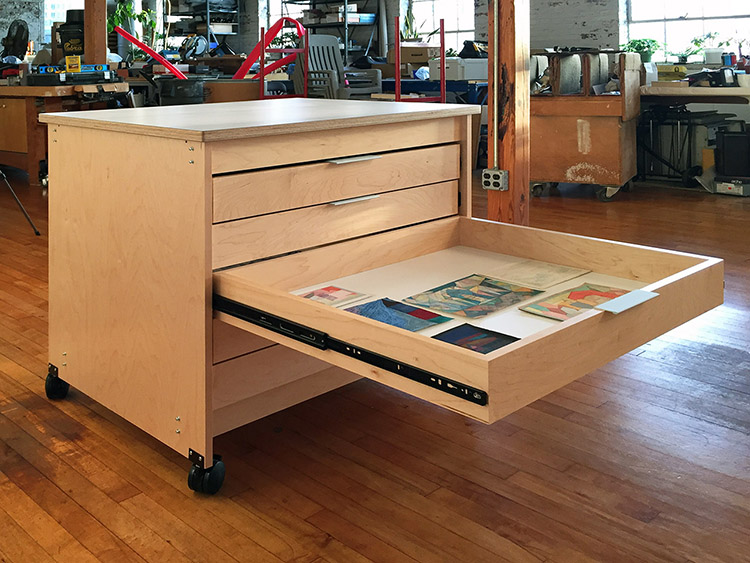 Art Studio Furniture rolls on locking wheels it has five full extension mobile art storage drawers for the well-organized artist studio. The interior drawer dimensions are 37" x 31", the inside drawer depth is 3 5/8". The counter is 1" thick, it has a white laminate work surface and it measures 42.5" x 35.5"