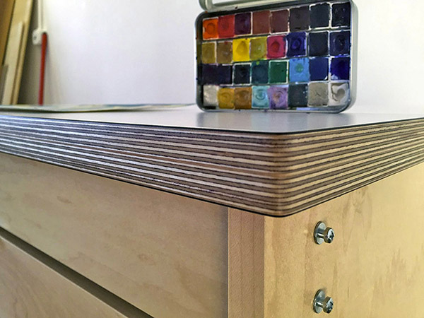 Art Boards™ Mobile Art Studio Worktable for making art and storing art measures 42 1/2" x 35 1/2" The top counter for making art is 1" thick.  The counter is a white durable high pressure laminate surface for easy cleaning. Residue from art materials will clean off without hurting the surface.  The interlayers of the counter are laminated birch hardwood. The sides have a hand rubbed urethane finish which both durable and beautiful. 