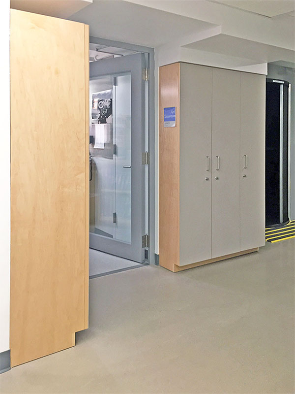 Two Tall Photography Studio Cabinetry with locking art storage doors.  Doors have a bulletin board surface for pinning photos and information.