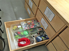 Sewing supply drawer in art school art studio classroom.