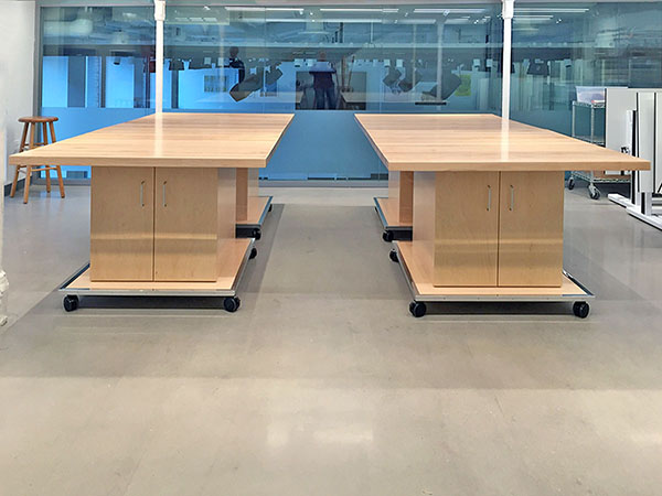 Two large conference size art studio tables are formed by connecting 4 smaller tables that each measure 48" x 48".