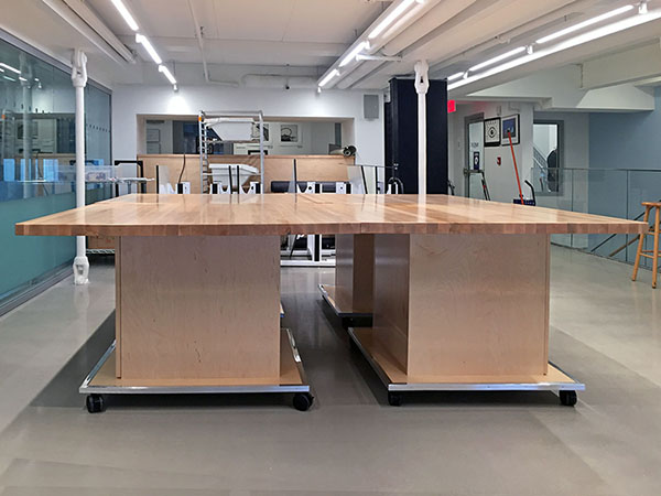 Modular Art Studio Tables nest together to make one large 8' x 8' art working surface in the schools fine arts department art mezzanine. 