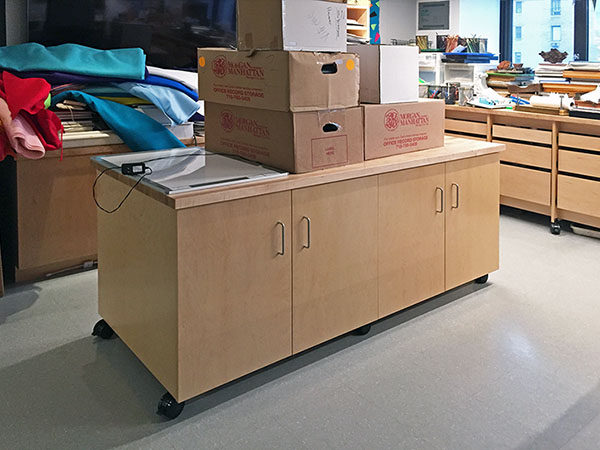 Art Studio Furniture in the school art classroom. the a large mobile work table is made for creating art, and for storing art, and art supplies