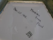 Antique ceramic art object dispayed on a white lacquered sculpture base.