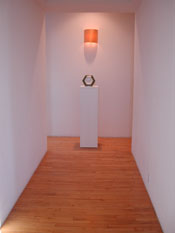 Sculpture stand for the ceramic arts in the museum hallway.