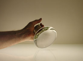 Muller held in the hand showing the approximate a 5 inch diameter base.
